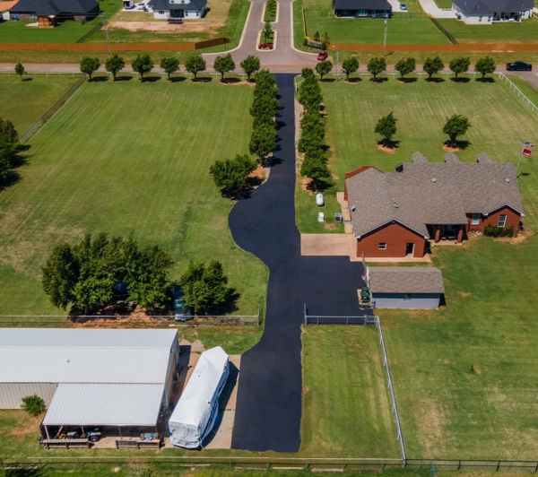 country farm house with asphalt driveway